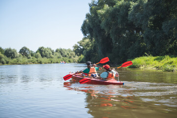 a team of athletes on a canoe overcomes obstacles floating on the river
