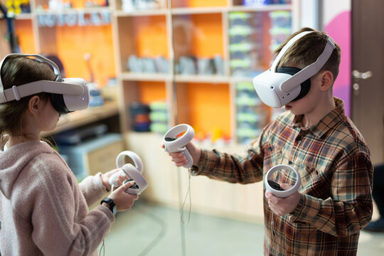 a child in virtual reality glasses plays a game - Powered by Adobe