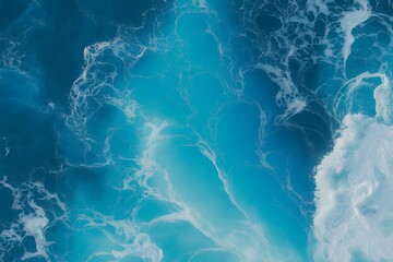 Aerial view of swirling turquoise ocean water with white foam patterns