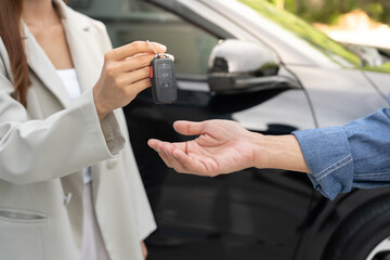 lease, rental car, sell, buy. Dealership manager send car keys to the new owner.  Sales, loan...