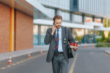 Stressed Man in Business Suit Walks and Talks on the Phone Outside
