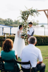 wedding ceremony of a young couple in love on a green meadow