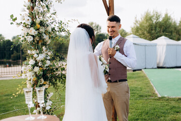 wedding ceremony of a young couple in love on a green meadow