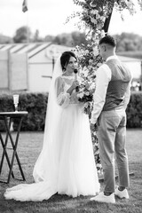 wedding ceremony of a young couple in love on a green meadow