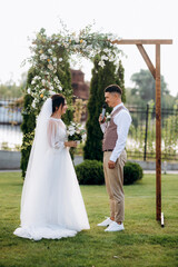 wedding ceremony of a young couple in love on a green meadow