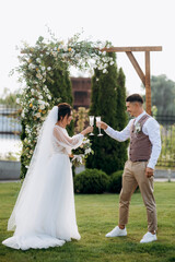 wedding ceremony of a young couple in love on a green meadow