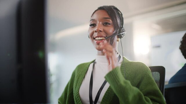 Smiling young african american professional customer support CRM Talking To Caller In Customer Services Department, Young Businesswoman Wearing Telephone Headset, Diverse call center team working - Powered by Adobe