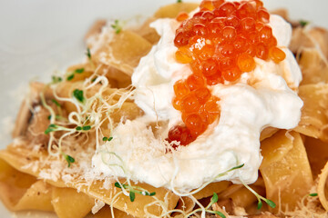 Sumptuous papardelle with burrata, salmon roe, sprouts, and parmesan cheese garnish