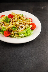 Bean salad green leaf lettuce, tomato, onion vegetables dish fresh delicious gourmet food background on the table rustic food top view copy space keto and paleo diet vegan and vegetarian food