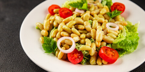 Bean salad green leaf lettuce, tomato, onion vegetables dish fresh delicious gourmet food background on the table rustic food top view copy space keto and paleo diet vegan and vegetarian food