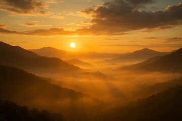 Naklejka premium Golden sunrise over misty mountains with soft clouds and warm light beams