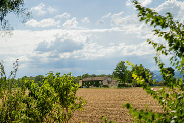 Landscape of a French village with small houses and a field.