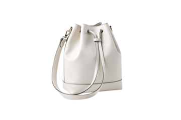 Cream colored leather bucket bag with drawstring closure and detachable crossbody strap, isolated on a transparent background