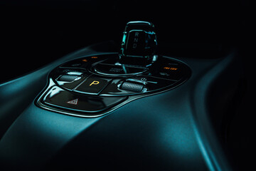 Close-up view of an electric vehicle's center console, showcasing the control panel, which...