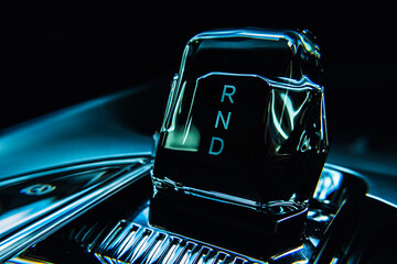 Close-up view of an electric vehicle's center console, showcasing the control panel, which...