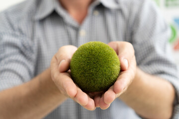 A diverse business team analyzing environmental charts and graphs in a collaborative meeting to create sustainable strategies in a modern office.