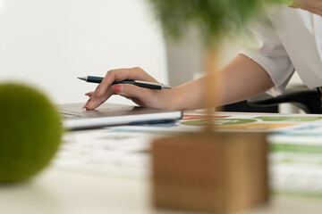 A diverse business team analyzing environmental charts and graphs in a collaborative meeting to create sustainable strategies in a modern office.