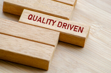 Quality Driven text on wooden blocks. Business and Quality control concept