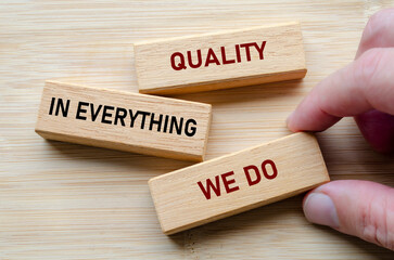 Quality in everything we do message on wooden blocks highlights a commitment to delivering consistent excellence