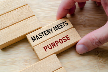 Mastery meets purpose text wooden block held in hand reflects skill, control, and experience achieved through practice