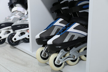 Pairs of roller skates in shelving unit, closeup