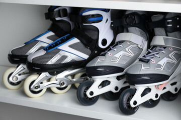 Pairs of roller skates in shelving unit, closeup