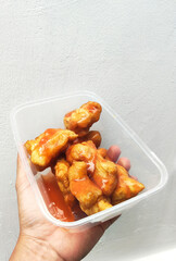 Hand Holding Sweet Glazed Cakwe Snack Container