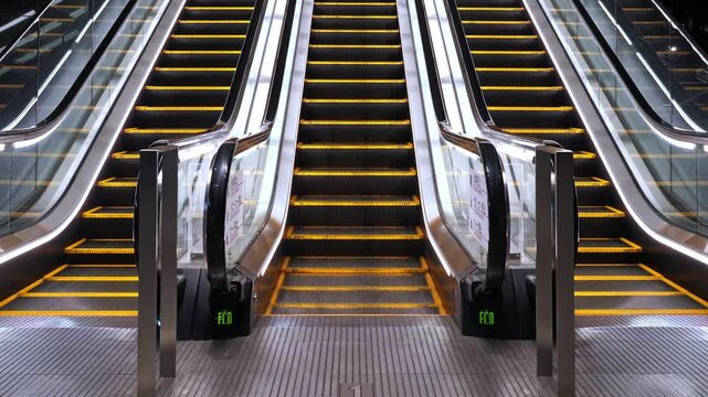 Two contemporary escalators with glowing steps, ready to transport commuters in a busy Tokyo station or commercial building.