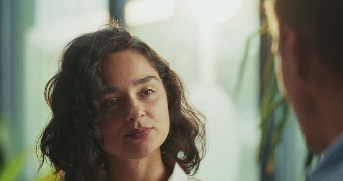  Close-up slow motion of young woman at the office talking to her coworker crush