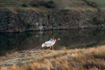 bride girl and groom near the river