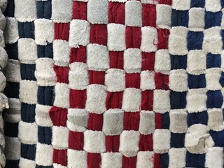 Close-Up of Rustic Woven Textile with Soft Fabric Strips. Traditional Checkered Woven Cloth –...