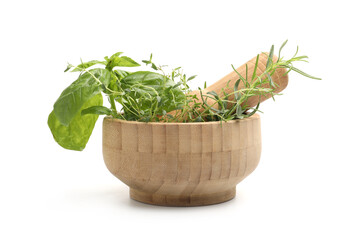 Mortar with pestle and different aromatic herbs isolated on white