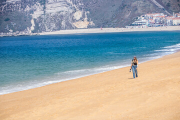 young woman walking on the beach