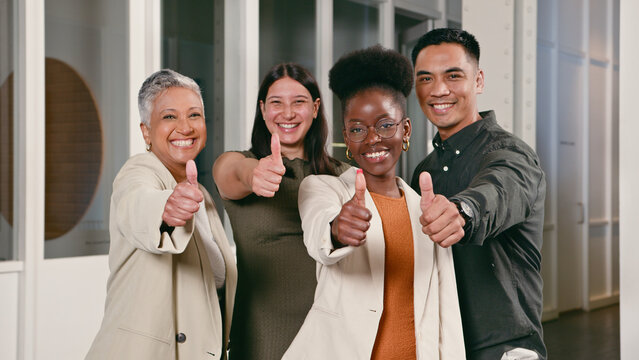 Diverse Group of Professionals Giving Enthusiastic Thumbs Up in Office Setting