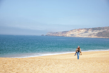 young woman walking on the beach