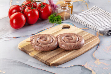 Raw meat pork and beef swirl sausages