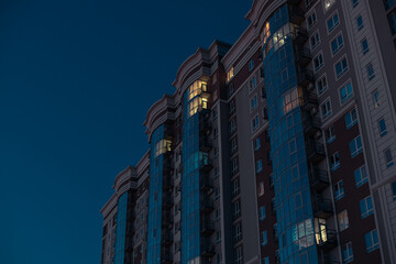 long exposure multi apartment living skyscraper building with design style glass facade and light...