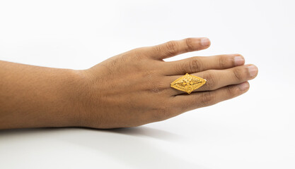 gold wedding ring in a hand on white background