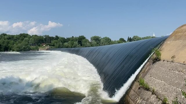 A hydroelectric dam used to generate electricity flows into a river