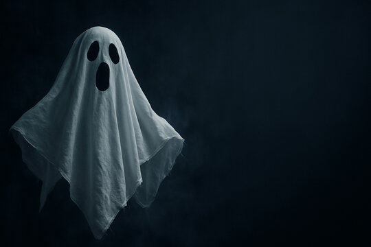 A traditional white sheet ghost floats ominously against a dark, misty background. The wide-open black eyes and mouth give it a startled expression, embodying the iconic Halloween ghost.