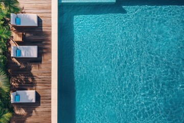 Swimming pool with wooden planks. Swimming pool top view. Sun loungers on terrace