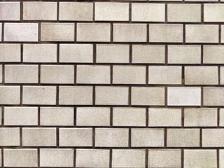 Detailed view of a textured wall showcasing rectangular concrete bricks with a muted color scheme ideal for background use