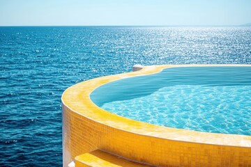 Yellow swimming pool. Round swimming pool with sea view. Colored tiles on terrace