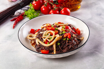 Black rice pasta with squid and tomato