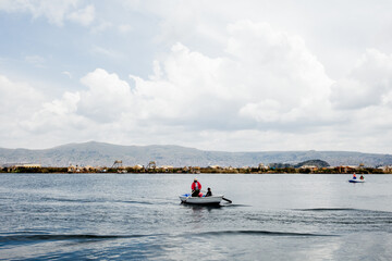 Uru´s boat sailing across Titicaca lake in Peruvian Andes