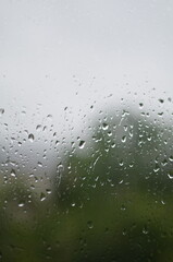 Rain drops on window, blurred background