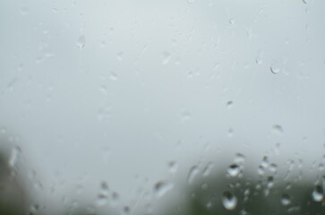 Rain drops on window, blurred background