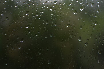 Rain drops on window, blurred background
