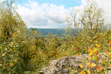 Landscape with rocks and boulders with green trees on a clear sunny day. Mountains, forests,...