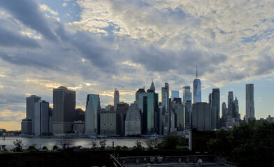 Fototapeta premium beautiful sky glow colorful sunset new york city skyline silhoutte manhattan skyscrapers clouds summer east river boats waterfront harbor travel tourism usa america